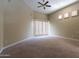 Bright bedroom with carpet, ceiling fan, and sliding door access at 8100 E Camelback Rd # 178, Scottsdale, AZ 85251