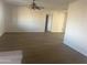 Spacious, bright living room with wood-look flooring and a ceiling fan at 312 S Elmont Dr, Apache Junction, AZ 85120