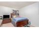 Bedroom with wood bed frame and dresser at 5921 W Golden Ln, Glendale, AZ 85302