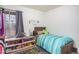 Bedroom with twin bed, dresser, and toy area at 5921 W Golden Ln, Glendale, AZ 85302