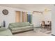 Living area with green sofas, dining area, and sliding door at 5921 W Golden Ln, Glendale, AZ 85302