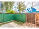 Small, private backyard with a green privacy fence at 5921 W Golden Ln, Glendale, AZ 85302