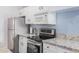 Kitchen with stainless steel appliances and granite countertops at 5921 W Golden Ln, Glendale, AZ 85302