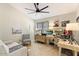 Home office with built-in desk and ceiling fan at 14194 W Mountain Laurel Trl, Surprise, AZ 85374