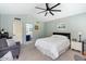 Guest bedroom with ceiling fan and access to bathroom at 14194 W Mountain Laurel Trl, Surprise, AZ 85374