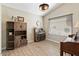 Bright home office features built-in shelving, wood flooring and large window at 14194 W Mountain Laurel Trl, Surprise, AZ 85374