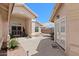 Inviting courtyard entry with pavered walkway, wrought iron gate, and seating area at 14194 W Mountain Laurel Trl, Surprise, AZ 85374