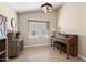 Home office with wood flooring, built-in shelving, and a classic piano at 14194 W Mountain Laurel Trl, Surprise, AZ 85374