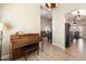 Bright entryway with a piano and view into the living room at 14194 W Mountain Laurel Trl, Surprise, AZ 85374