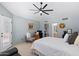 Bedroom with ceiling fan and access to private bathroom at 14194 W Mountain Laurel Trl, Surprise, AZ 85374