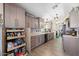 Well-equipped kitchen featuring a large pantry, modern cabinets, and granite countertops at 14194 W Mountain Laurel Trl, Surprise, AZ 85374