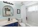 Updated bathroom with a blue vanity, white fixtures, and a shower/tub combo at 14194 W Mountain Laurel Trl, Surprise, AZ 85374