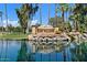 Sun Village entrance with a pond and palm trees at 14194 W Mountain Laurel Trl, Surprise, AZ 85374