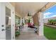 Covered patio with seating area, ceiling fan, and access to backyard at 14194 W Mountain Laurel Trl, Surprise, AZ 85374