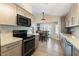 Updated kitchen with stainless steel appliances, light wood cabinets and tile floors at 14194 W Mountain Laurel Trl, Surprise, AZ 85374