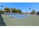 Two well-maintained tennis courts with seating area at 14194 W Mountain Laurel Trl, Surprise, AZ 85374