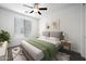 Guest bedroom with green bedding and ceiling fan at 901 S Smith Rd # 1012, Tempe, AZ 85281