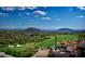 Aerial view of luxury homes and golf course with mountain backdrop at 42035 N 113Th Way, Scottsdale, AZ 85262