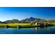 Scenic view of Desert Mountain golf course with lake and mountain backdrop at 42035 N 113Th Way, Scottsdale, AZ 85262