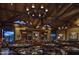 Upscale restaurant interior with wooden beams, chandeliers, and comfortable seating at 42035 N 113Th Way, Scottsdale, AZ 85262