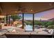 Relaxing covered patio overlooking the pool and mountains at sunset at 42035 N 113Th Way, Scottsdale, AZ 85262