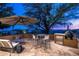 Relaxing patio with seating, umbrella, and mountain views at 42035 N 113Th Way, Scottsdale, AZ 85262