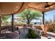 Covered patio features a dining area, lounge chairs, and a grill at 42035 N 113Th Way, Scottsdale, AZ 85262
