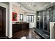Elegant bathroom with dark wood cabinets, large walk-in shower, and granite vanity at 42035 N 113Th Way, Scottsdale, AZ 85262