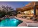 Luxury pool and patio at dusk with desert landscaping at 42035 N 113Th Way, Scottsdale, AZ 85262