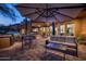 Evening view of patio with seating, grill and outdoor lighting at 42035 N 113Th Way, Scottsdale, AZ 85262