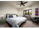 Bedroom with a king-size bed, ceiling fan, and picturesque views at 42035 N 113Th Way, Scottsdale, AZ 85262
