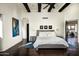 Spacious main bedroom with wood floors, large bed, and access to another room at 42035 N 113Th Way, Scottsdale, AZ 85262