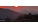 Spectacular sunset over mountain range with home in foreground at 42035 N 113Th Way, Scottsdale, AZ 85262
