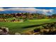 Stunning golf course view with a luxury home in the background at 42035 N 113Th Way, Scottsdale, AZ 85262