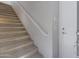 Carpeted staircase with white railing and door at 15240 N 142Nd Ave # 2111, Surprise, AZ 85379