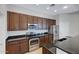 Kitchen with dark wood cabinets, granite counters, and stainless steel appliances at 15240 N 142Nd Ave # 2111, Surprise, AZ 85379