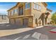 Tan building with three garage doors and a balcony at 15240 N 142Nd Ave # 2111, Surprise, AZ 85379