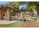 Community playground with play structures and shaded seating area at 15240 N 142Nd Ave # 2111, Surprise, AZ 85379