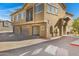 Tan building with three garage doors and a balcony at 15240 N 142Nd Ave # 2111, Surprise, AZ 85379