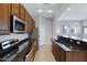 Modern kitchen features dark wood cabinets, granite countertops, and stainless steel appliances at 15240 N 142Nd Ave # 2111, Surprise, AZ 85379