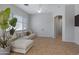 Spacious living room with light colored sectional sofa and tile floors at 15240 N 142Nd Ave # 2111, Surprise, AZ 85379