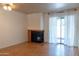 Living room with a fireplace, sliding glass doors and laminate flooring at 1065 W 1St St # 114, Tempe, AZ 85281