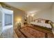 Bedroom with daybed, wood-look floors and decorative rug at 6601 N 79Th Pl, Scottsdale, AZ 85250