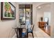 Bright dining area with glass table and metal chairs, offering a view of the courtyard at 6900 E Princess Dr # 1136, Phoenix, AZ 85054