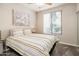 Cozy bedroom with striped bedding and window coverings at 6900 E Princess Dr # 1136, Phoenix, AZ 85054