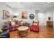 Open living area with hardwood floors, sofa, and red chaise lounge at 6900 E Princess Dr # 1136, Phoenix, AZ 85054
