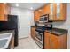Clean and efficient kitchen with wood cabinets and granite counters at 6900 E Princess Dr # 1136, Phoenix, AZ 85054