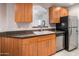 Modern kitchen featuring wood cabinets and granite countertops at 6900 E Princess Dr # 1136, Phoenix, AZ 85054