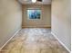 Bright bedroom with tile floors and large window at 13049 W Redbird Rd, Peoria, AZ 85383