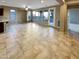 Open living area with tile floors and access to patio at 13049 W Redbird Rd, Peoria, AZ 85383